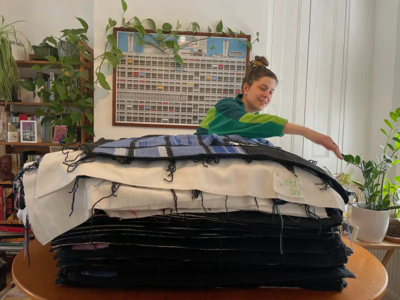 Caroline Murray with the full pile of knitted data calendars