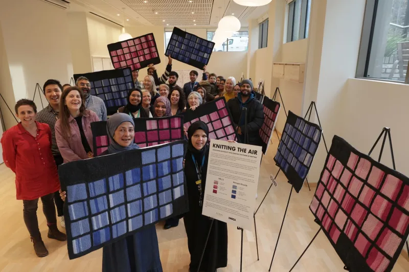 November 2024. Picture with the Aberfeldy Practice, who have helped knit many squares, during a work in progress exhibition at the Aberfeldy Health and Wellbeing Centre where their surgery is based. Photo credit: Rehan Jamil