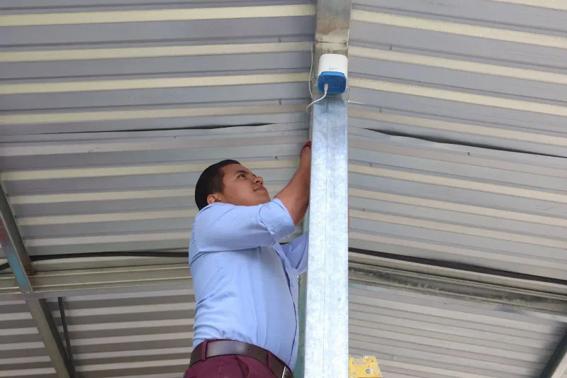 The installation of the outdoor air quality monitor in the town of Lamani.